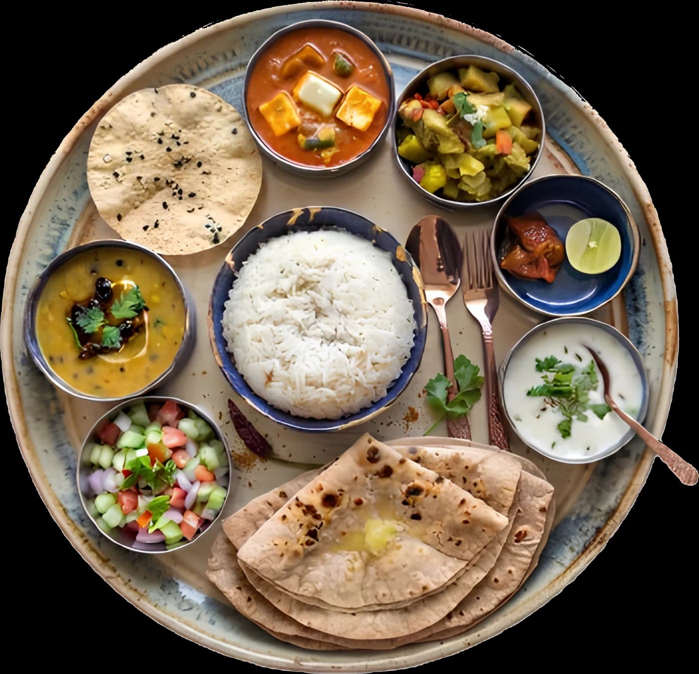 A thali — dal, paneer curry, sabzi, steamed rice, roti, papad, salad, raita, pickle and lime